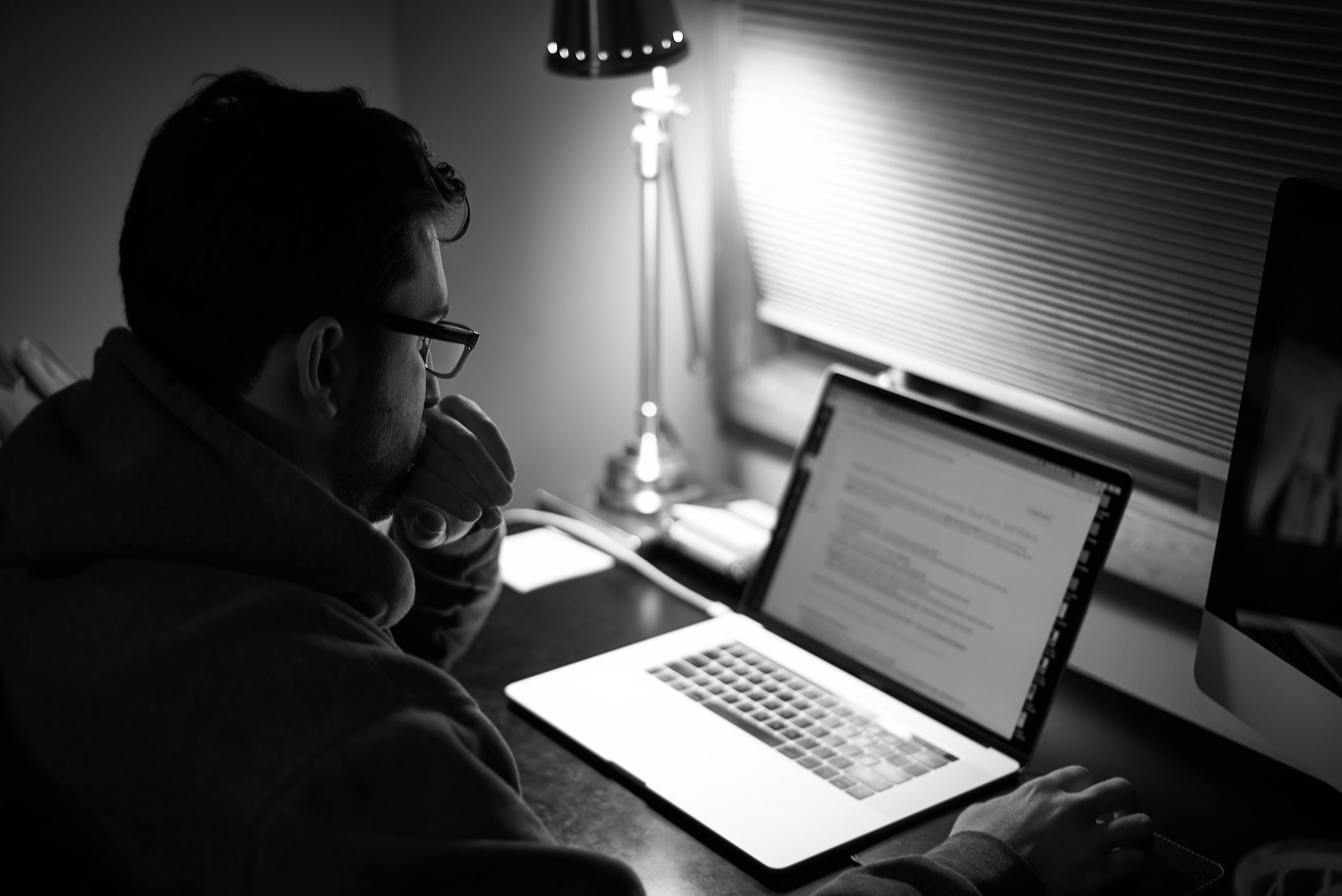 Side View Of Man Using Laptop In Darkroom